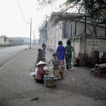 Những đứa trẻ vây quanh một gánh hàng quà vặt trên đường Phạm Ngũ Lão, gần ga tàu hỏa.